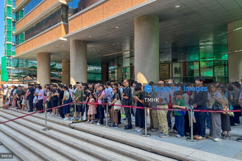 Attendees, faculty members, and students stand and watch as the national and regional flags are hoisted during the 77th National Day flag-raising ceremony held on the campus of The Hong Kong Polytechnic University (PolyU) on October 1, 2026 in Hong Kong. (Photo by Peter Tsang/TMHK via Nexpher Images)