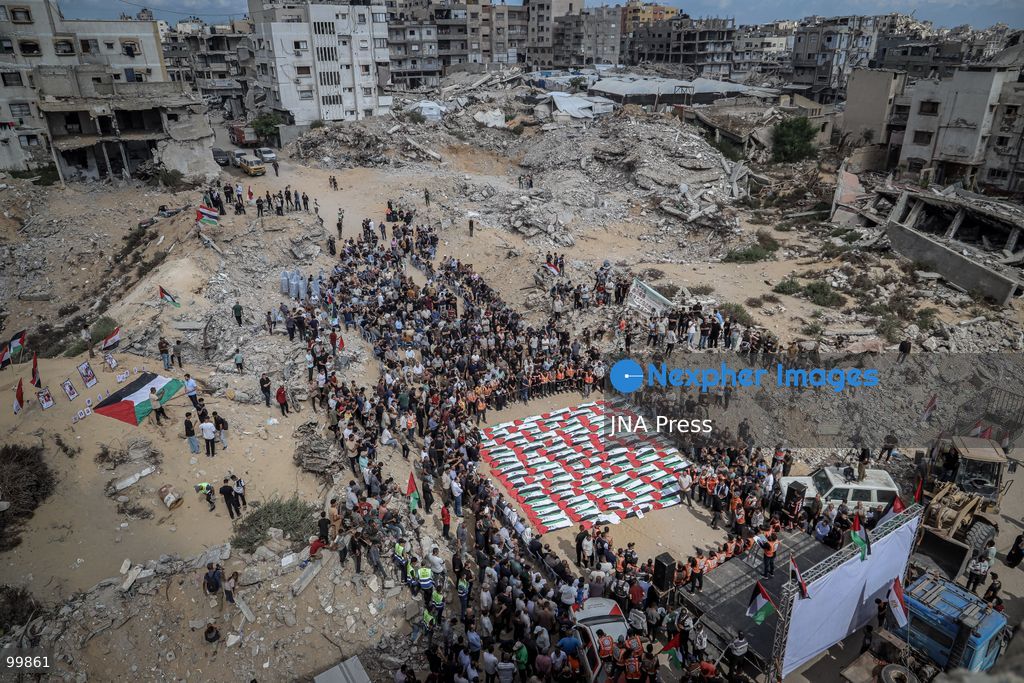 GAZA CITY, GAZA STRIP, OCTOBER 1, 2026: Palestinian families bid farewell to the remains of 105 Palestinians whose bodies were recovered from beneath the rubble of the Al-Taj residential area in Gaza City. The victims were killed in Israeli airstrikes on October 25, 2023, when residential buildings in the Yarmouk area were destroyed. Gaza Civil Defense teams recovered the bodies and remains after a 17-day search operation carried out in coordination with an Egyptian committee. Families gathered to identify their relatives and pay their final respects before burial. Photo by Mohammed M. Skaik / JNA Press. (Photo by Mohammed M Skaik/JNA Press via Nexpher Images)