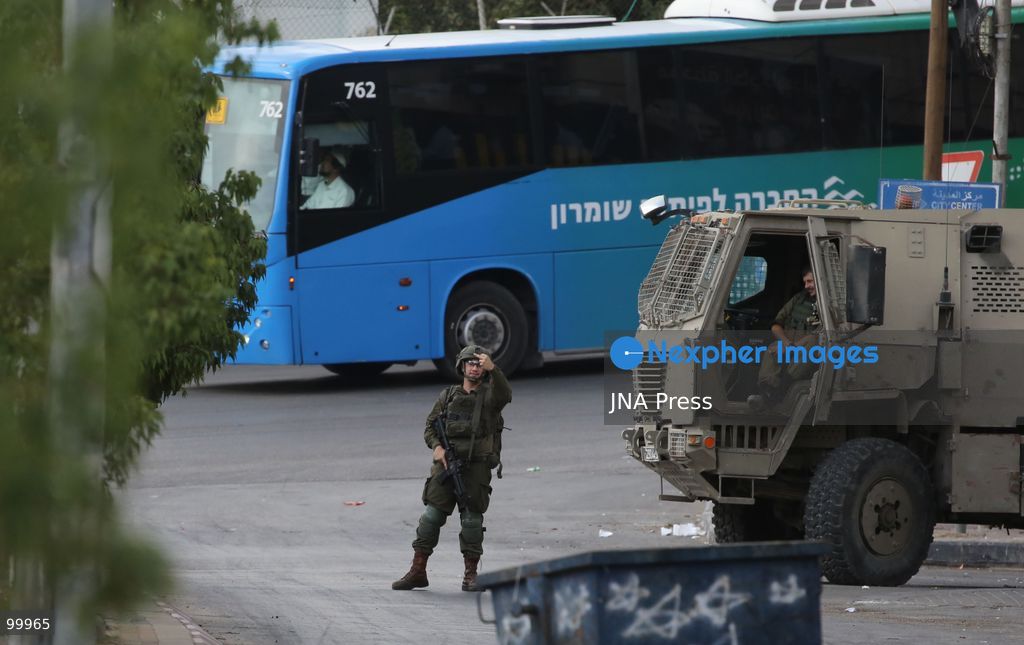 NABLUS, OCCUPIED WEST BANK, OCTOBER 1, 2026: Israeli soldiers guard Israeli settlers during a raid on Joseph's Tomb in the eastern part of Nablus. Hundreds of Israeli settlers entered the site to perform Jewish religious rituals under heavy protection from Israeli forces, which deployed military vehicles and imposed security restrictions around the area. Photo by Nedal Shtieh / JNA Press. (Photo by Nedal Shtieh/JNA Press via Nexpher Images)