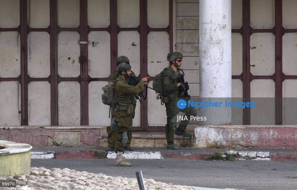 NABLUS, OCCUPIED WEST BANK, OCTOBER 1, 2026: Israeli soldiers guard Israeli settlers during a raid on Joseph's Tomb in the eastern part of Nablus. Hundreds of Israeli settlers entered the site to perform Jewish religious rituals under heavy protection from Israeli forces, which deployed military vehicles and imposed security restrictions around the area. Photo by Nedal Shtieh / JNA Press. (Photo by Nedal Shtieh/JNA Press via Nexpher Images)