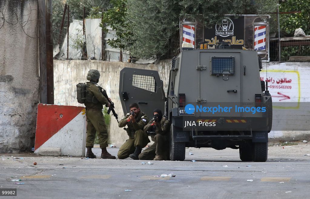 NABLUS, OCCUPIED WEST BANK, OCTOBER 1, 2026: Israeli soldiers guard Israeli settlers during a raid on Joseph's Tomb in the eastern part of Nablus. Hundreds of Israeli settlers entered the site to perform Jewish religious rituals under heavy protection from Israeli forces, which deployed military vehicles and imposed security restrictions around the area. Photo by Nedal Shtieh / JNA Press. (Photo by Nedal Shtieh/JNA Press via Nexpher Images)