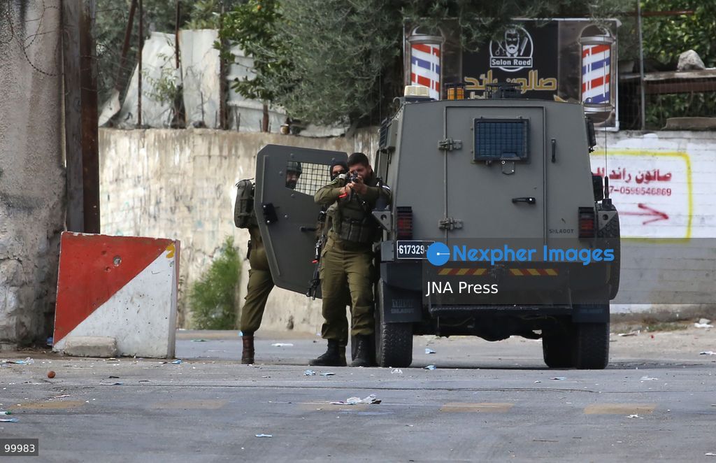 NABLUS, OCCUPIED WEST BANK, OCTOBER 1, 2026: Israeli soldiers guard Israeli settlers during a raid on Joseph's Tomb in the eastern part of Nablus. Hundreds of Israeli settlers entered the site to perform Jewish religious rituals under heavy protection from Israeli forces, which deployed military vehicles and imposed security restrictions around the area. Photo by Nedal Shtieh / JNA Press. (Photo by Nedal Shtieh/JNA Press via Nexpher Images)