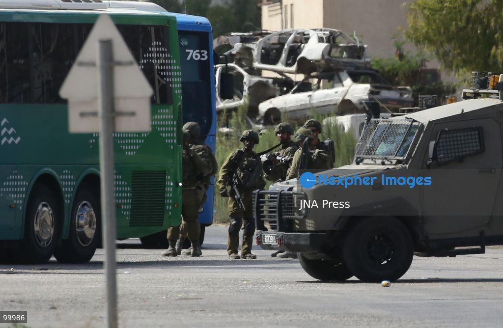 NABLUS, OCCUPIED WEST BANK, OCTOBER 1, 2026: Israeli soldiers guard Israeli settlers during a raid on Joseph's Tomb in the eastern part of Nablus. Hundreds of Israeli settlers entered the site to perform Jewish religious rituals under heavy protection from Israeli forces, which deployed military vehicles and imposed security restrictions around the area. Photo by Nedal Shtieh / JNA Press. (Photo by Nedal Shtieh/JNA Press via Nexpher Images)