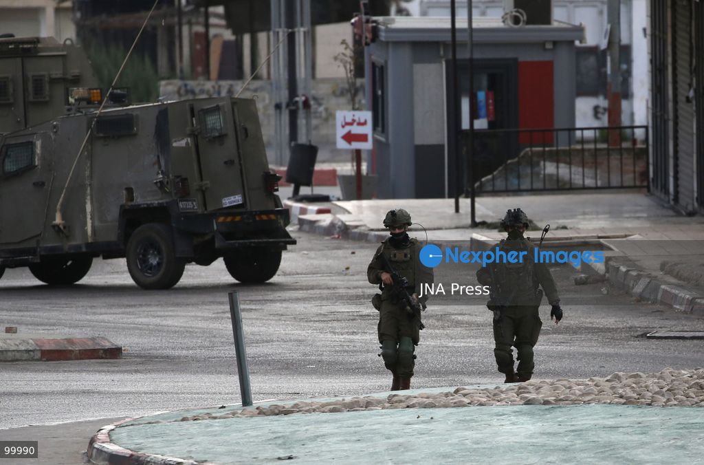 NABLUS, OCCUPIED WEST BANK, OCTOBER 1, 2026: Israeli soldiers guard Israeli settlers during a raid on Joseph's Tomb in the eastern part of Nablus. Hundreds of Israeli settlers entered the site to perform Jewish religious rituals under heavy protection from Israeli forces, which deployed military vehicles and imposed security restrictions around the area. Photo by Nedal Shtieh / JNA Press. (Photo by Nedal Shtieh/JNA Press via Nexpher Images)